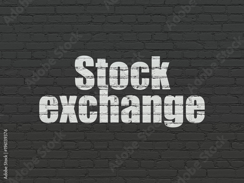Finance concept: Painted white text Stock Exchange on Black Brick wall background