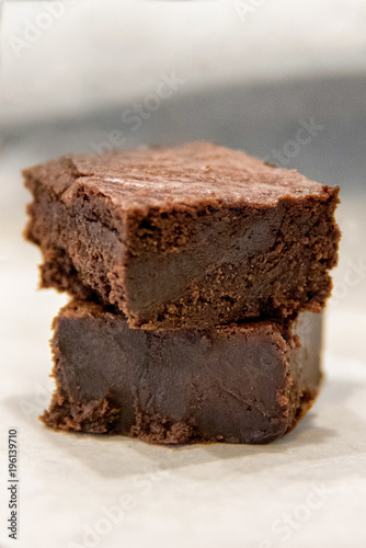 Stack of two dark chocolate chewy brownies