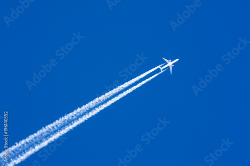 Quadro su tela White aircraft big two engines aviation airport contrail clouds.