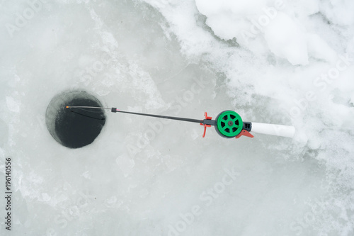 Fishing rod for winter fishing is on the ice. Wait for fish biting on winter fishing.