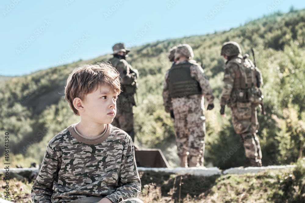 The boy is thinking about the war and his father. Concept