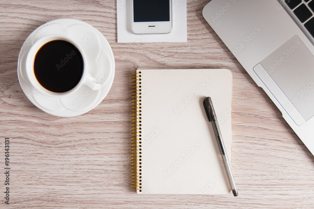 Notepad, laptop with pencil, smartphone and coffee cup on wood table. Flat lay. Notepad, laptop with pencil, smartphone and coffee cup on wood table. Flat lay.