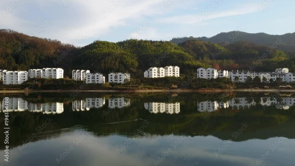Glassy Lake at Sunrise Towards Mountain City in Huangshan China Glassy Lake at Sunrise Towards Mountain City in Huangshan China