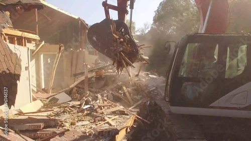 Close On Excavator Bucket Lifting Debris From Demolished House