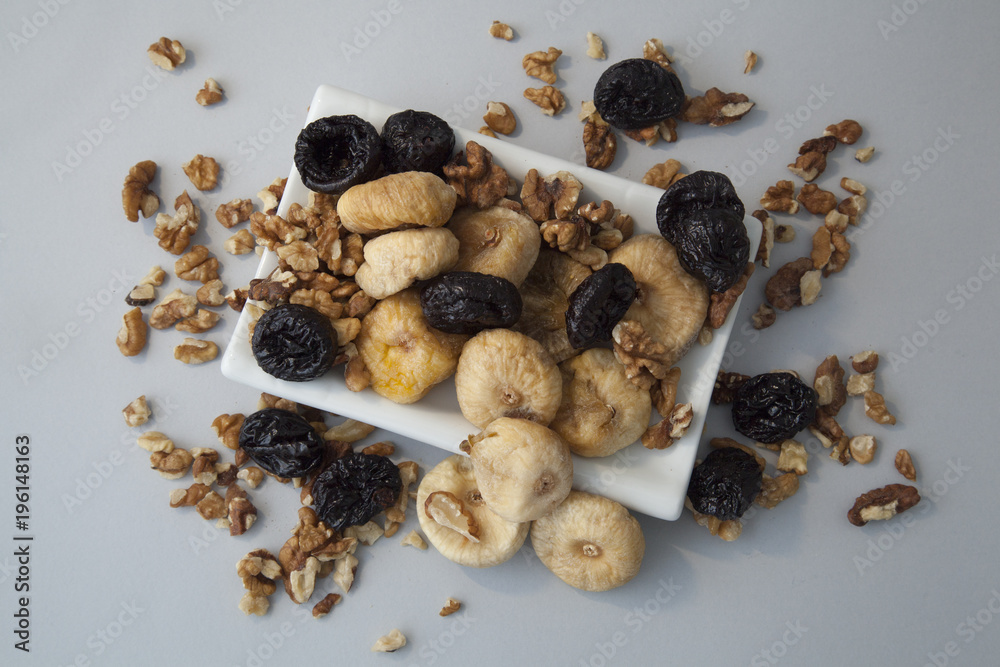 dryed figs and plums with nuts on white isolated background dryed figs and plums with nuts on white isolated background