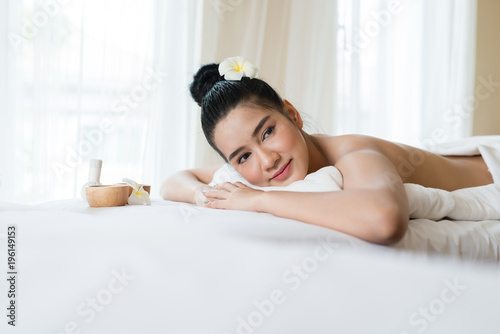 Beautiful Asian girl smile relaxing in the spa massage in salon