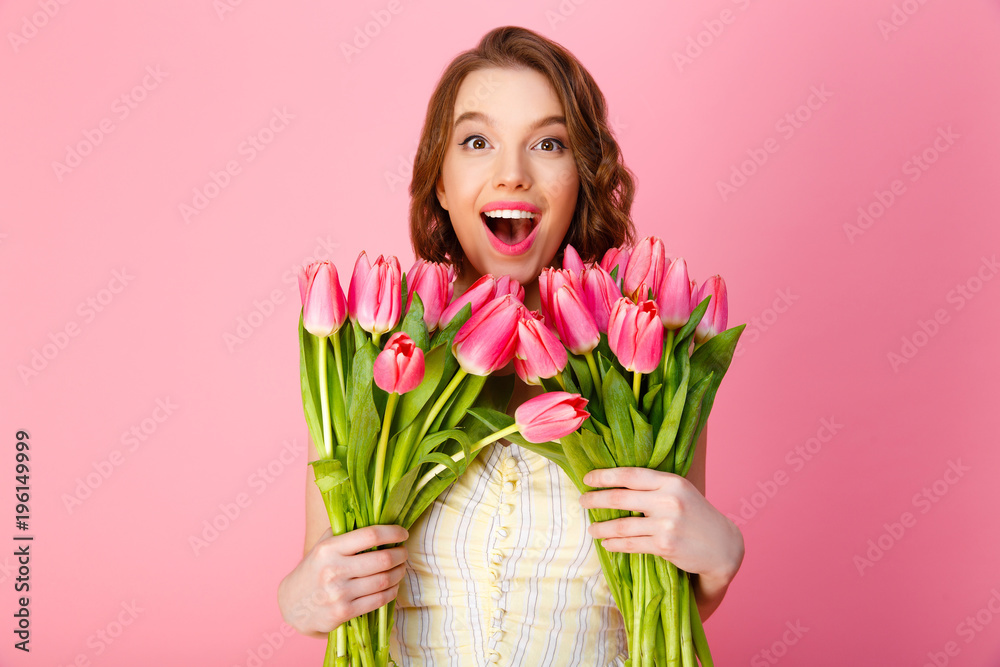 portrait of happy woman with bouquets of tulips isolated on pink portrait of happy woman with bouquets of tulips isolated on pink
