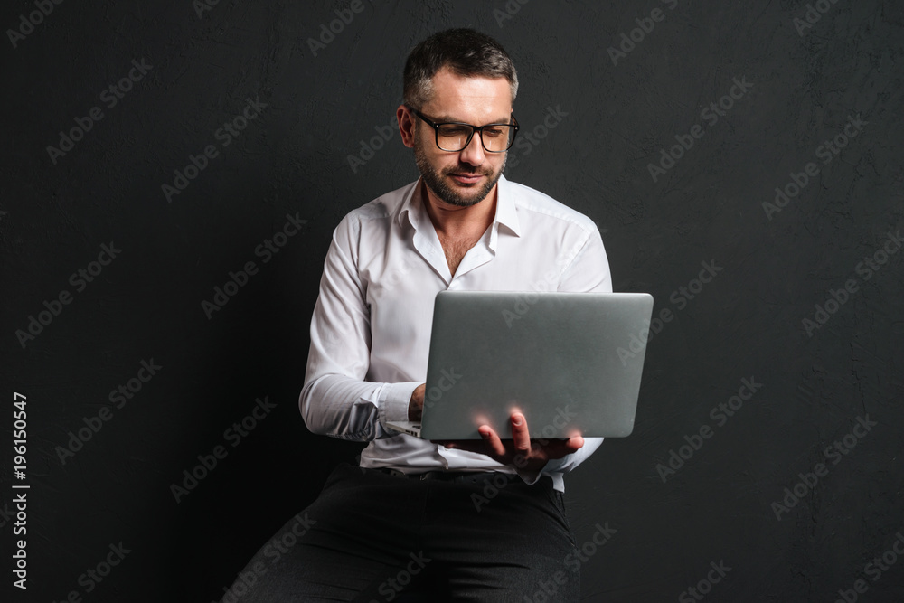 Concentrated businessman using laptop computer. Concentrated businessman using laptop computer.