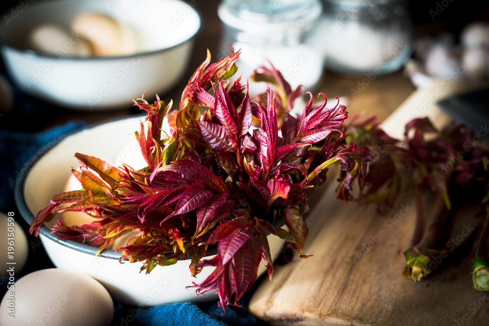 Toona sinensis on wooden table in kitchen Toona sinensis on wooden table in kitchen