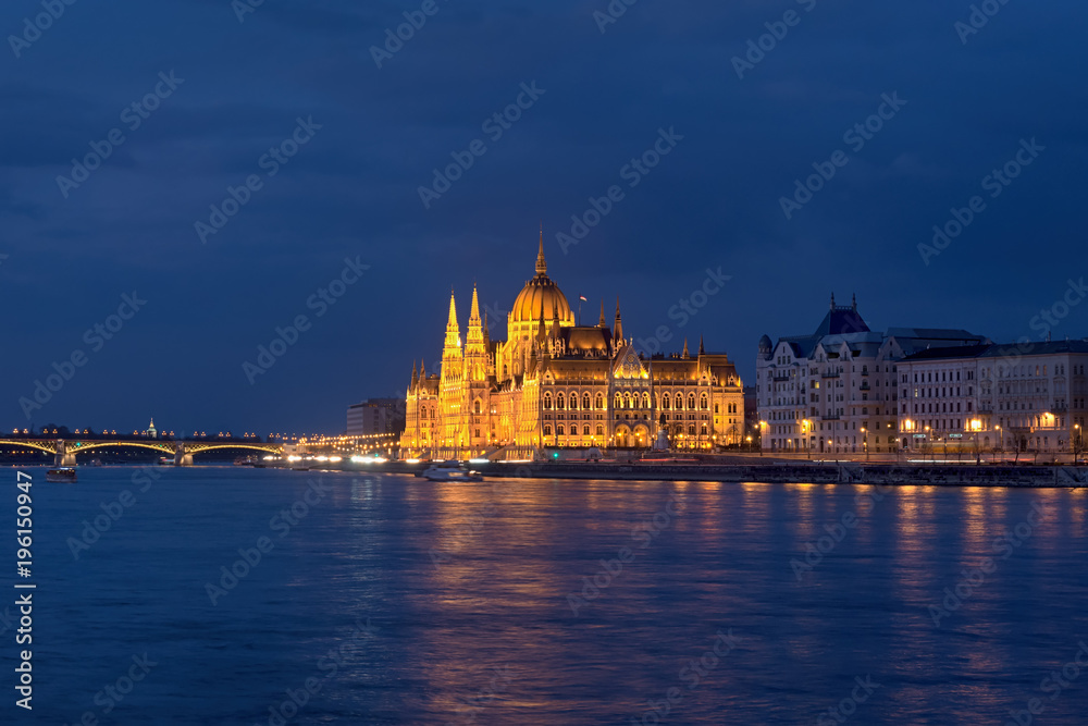 Parliament building in Budapest night view across Danube river