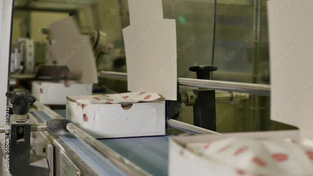 Industrial process of folding white boxes at the conveyor belt of a ...