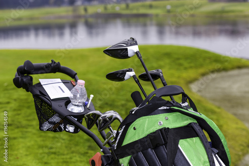 Golf cart with bag, golf clubs, water bottle and scorecard