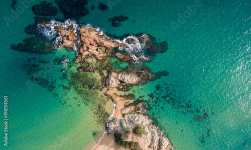 Aerial views of the rocks in the sea on a sunny day. photo