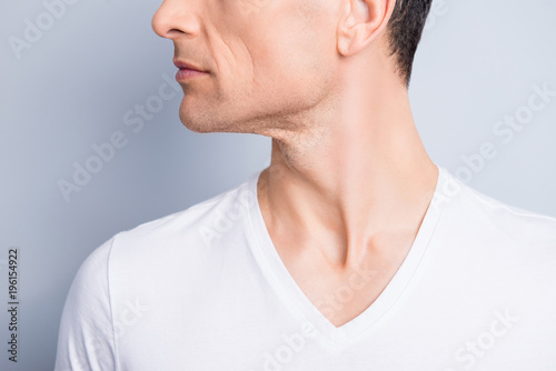 Cropped, close up profile, side view half face portrait of trendy, neat, experienced, stylish, brunet man with perfect oiled dry skin, isolated on grey background