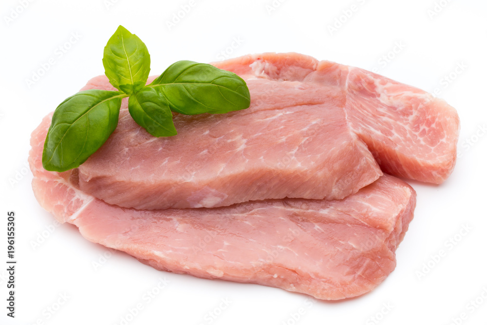 Fresh pork fillet with basil on a white background.