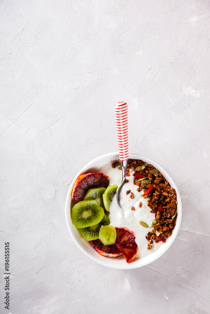 Granola,yogurt with kiwi and red oranges.Breakfast useful.Concept of Healthy Food.Copy space for Text. selective focus.