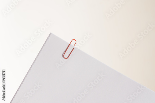 Some white papers clipped together. Represents reminders, documents or work papers.
