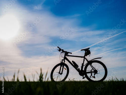 Bicycle silhouettes on the dark background of sunsets