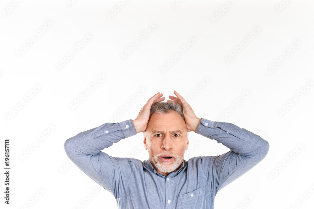 Shocked man looking camera while posing isolated over white Shocked man looking camera while posing isolated over white