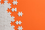 White details of puzzle on orange background