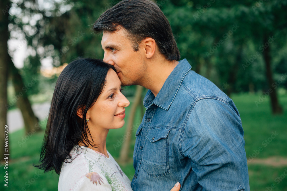 Young couple dating and flirting in park on sunset . Happy Man and pretty woman having fun outdoors. Young couple dating and flirting in park on sunset . Happy Man and pretty woman having fun outdoors.