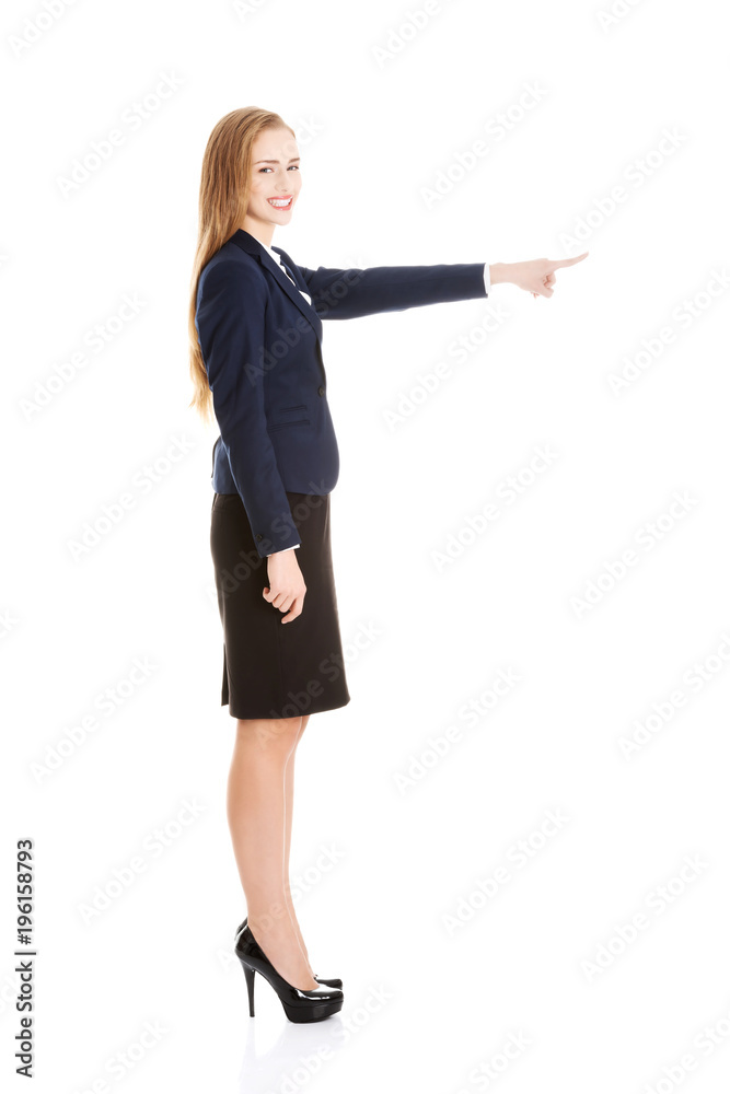 Beautiful business woman pointing on copy space. Beautiful business woman pointing on copy space.