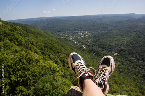 hiking boots having fun and enjoying wonderful breathtaking mountain view. Lifestyle and travel concept.