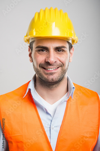 Portrait of young architect wearing helmet and smiling