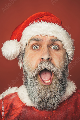 Waiting Christmas and New Year. New Year, Christmas and winter time - surprised bearded Santa Claus with frozen beard. Family holidays.