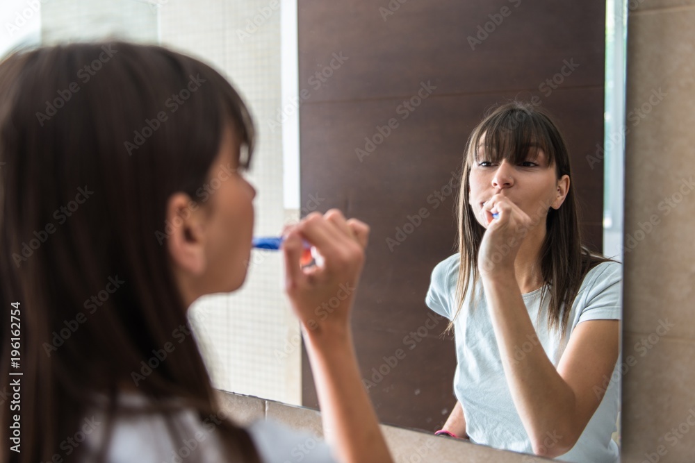 Beautiful young girl brushing teeth Beautiful young girl brushing teeth
