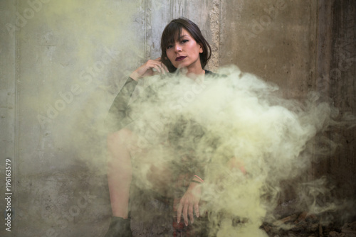 Beautiful young girl with smoke bomb