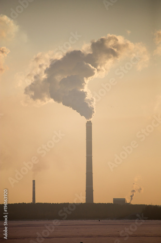 Smoke from the pipes of an industrial plant in the morning