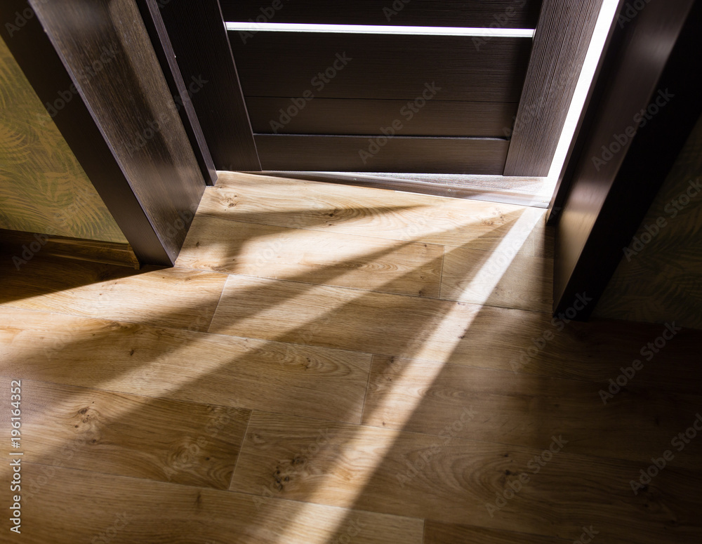 Rays of light from the door in a dark room Rays of light from the door in a dark room
