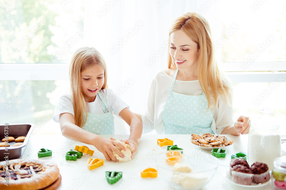 Table handmade cupcakes joy fun enjoy blonde birthday holiday prepare raw support hobby motherhood parenthood concept. Cute portrait of mum  and daughter making dough shapes of xmas trees bunny stars