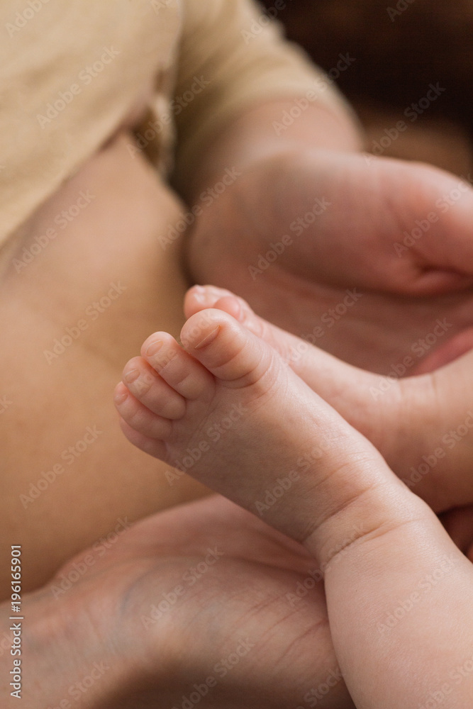 The legs of the baby on the belly of the mother The legs of the baby on the belly of the mother