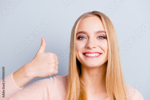 Finger up youth modern dimples model cosmetics dental concept. Close up portrait of funny cute lovely attractive woman clothed in warm pullover outfit demonstrating thumb-up isolated gray background