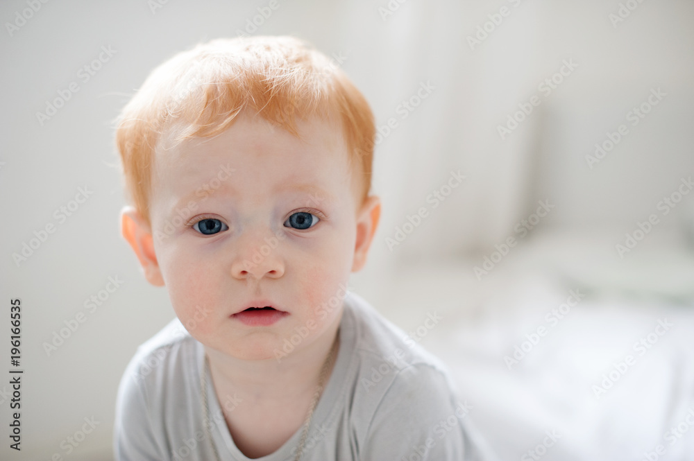The boy looks surprised closeup on the white background The boy looks surprised closeup on the white background
