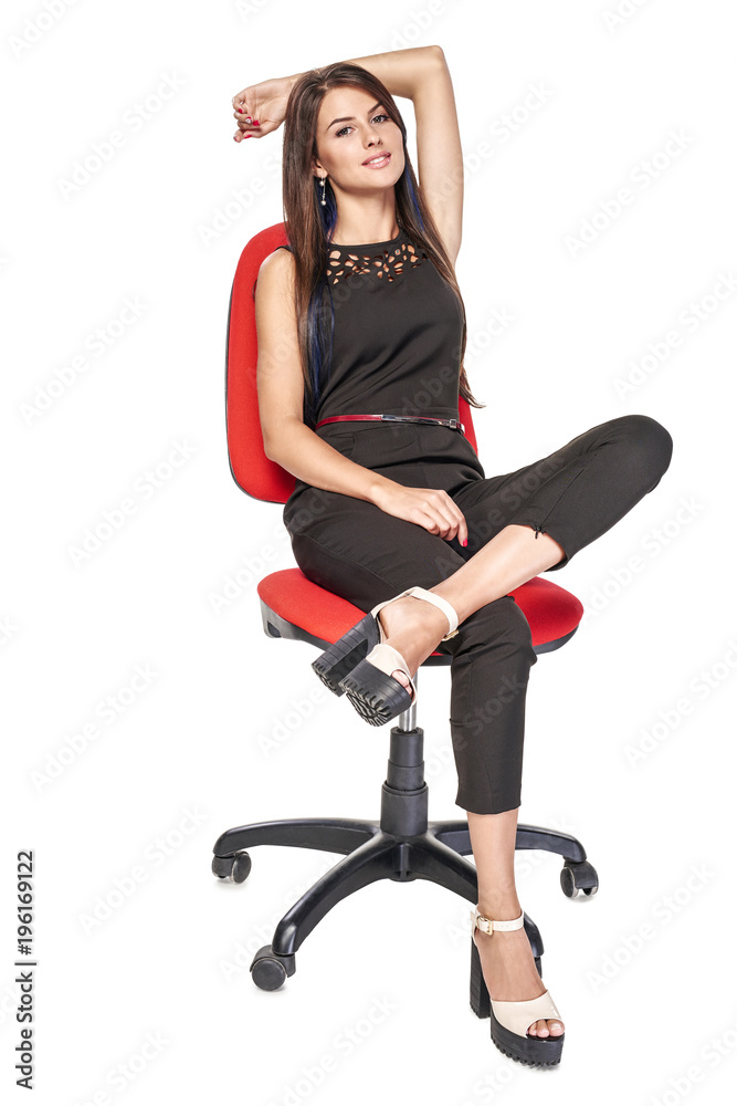 Smiling woman in black sitting on office chair smiling at camera, full length portrait Smiling woman in black sitting on office chair smiling at camera, full length portrait