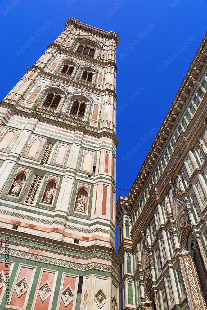 View of the bell tower of the Florence Cathedral. Detail of the facade of the Cathedral. Italian Gothic architectural style. June 2017, Italy.