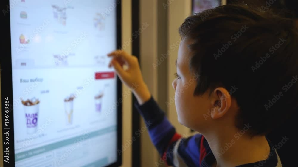 guy makes a purchase of food on the electronic terminal.