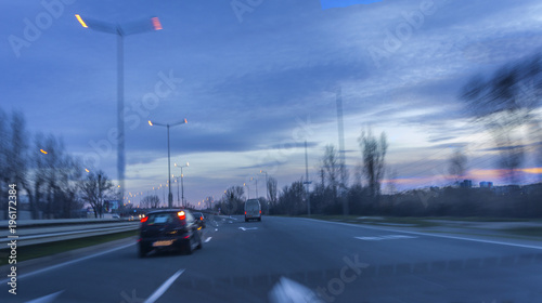 urban night landscape on a road with smashed high-speed cars. blurry effect of vehicle speed. © Ivan