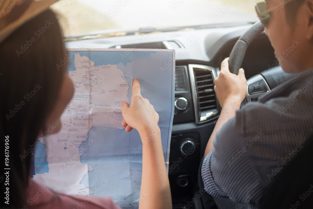 Couple in car with map. Man at the wheel. Couple in car with map. Man at the wheel.