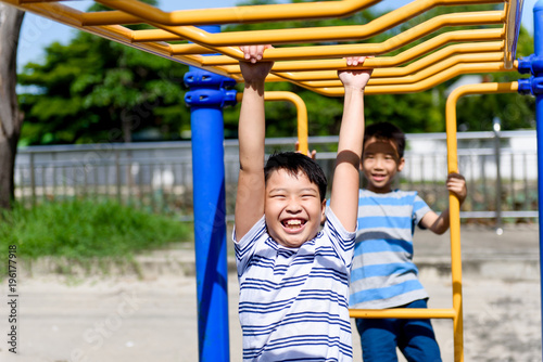 Young asian boy hang out door playground