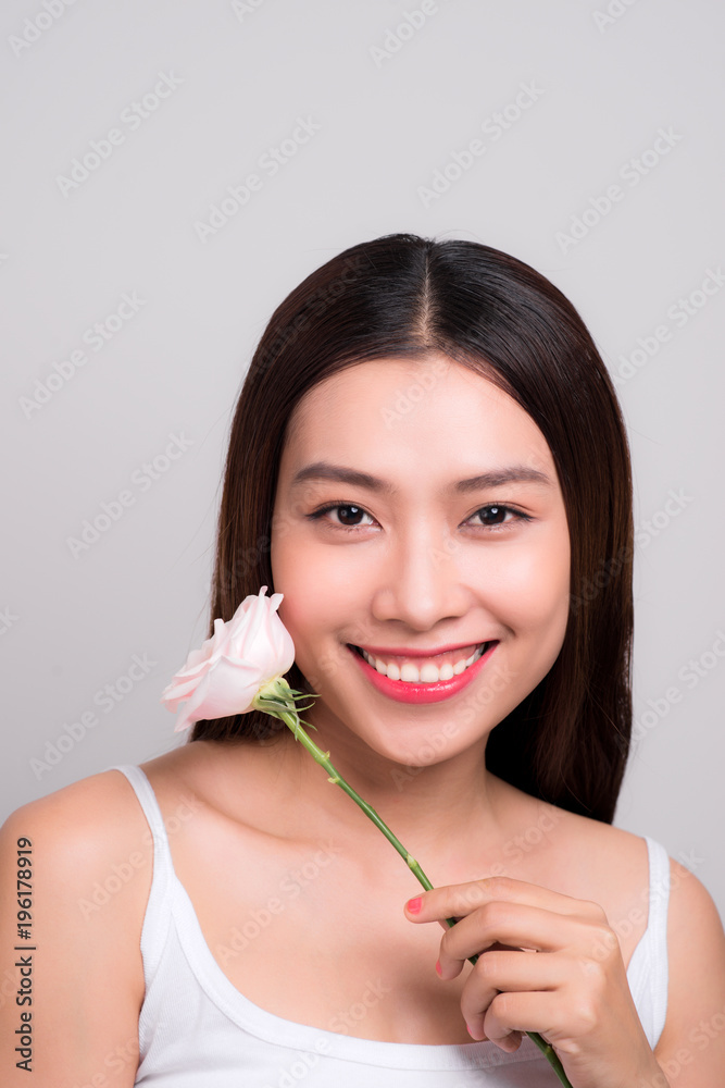 Beauty woman looking at camera with a rose flower