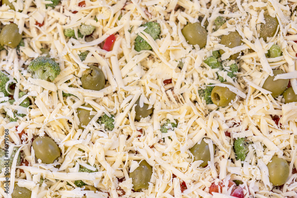 Pizza before baking. Background of grated cheese. Pizza before baking. Background of grated cheese.