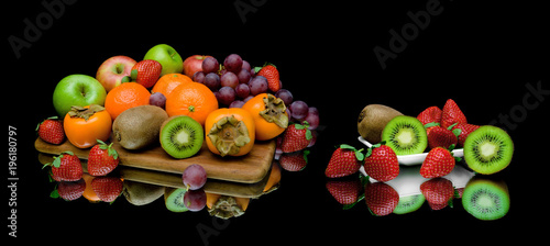 still life of fruit on a black background
