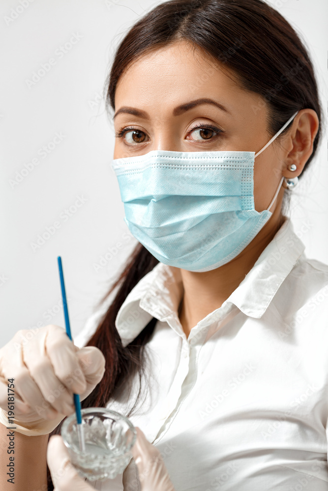 The cosmetologist prepares a mask