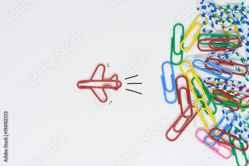 Business concept for group of stacked paperclip with another one red plane paperclip is point to another direction as a team leadership photo