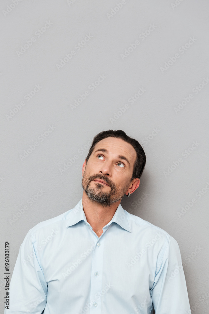 Portrait of a pensive mature man dressed in shirt