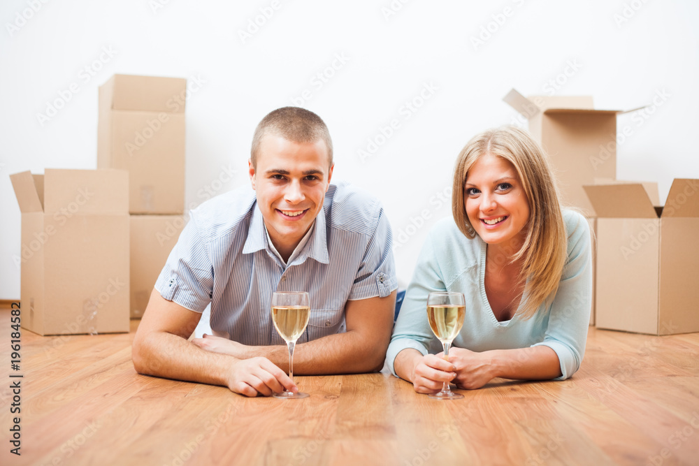 Young couple is moving to their new home. It's time for celebration. Young couple is moving to their new home. It's time for celebration.